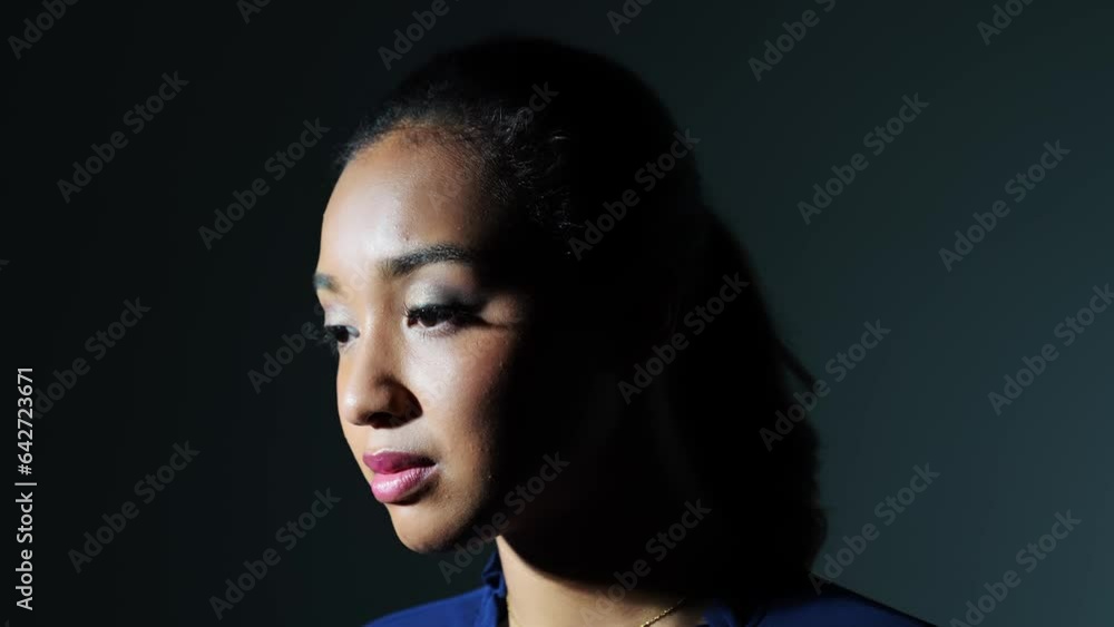 Young Black woman turn around in dark room. Young Black woman turn around in dark room.