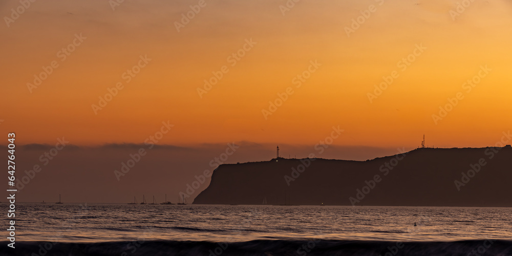 Point Loma and the Pacific Ocean from Coronado Island in San Diego, California, USA, during sunset.