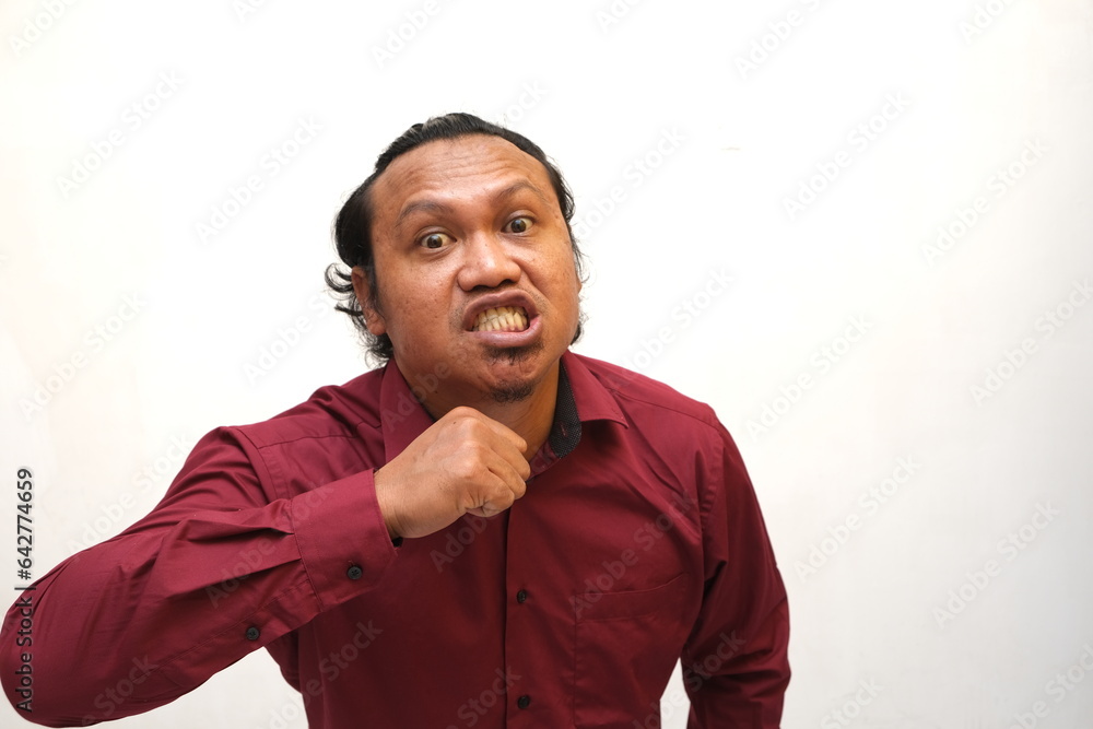 angry expression of asian man isolated on red background angry expression of asian man isolated on red background