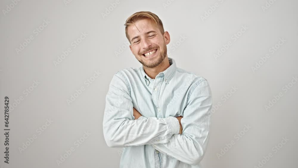 Young caucasian man smiling confident standing with arms crossed gesture over isolated white background Young caucasian man smiling confident standing with arms crossed gesture over isolated white background