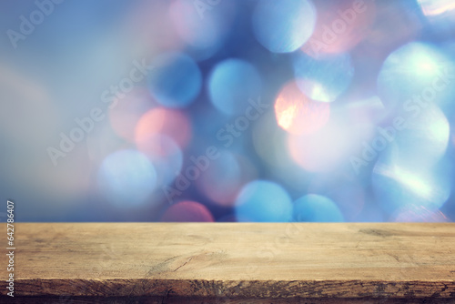 Empty table in front of christmas glitter bokeh background with lights. Ready for product display montage