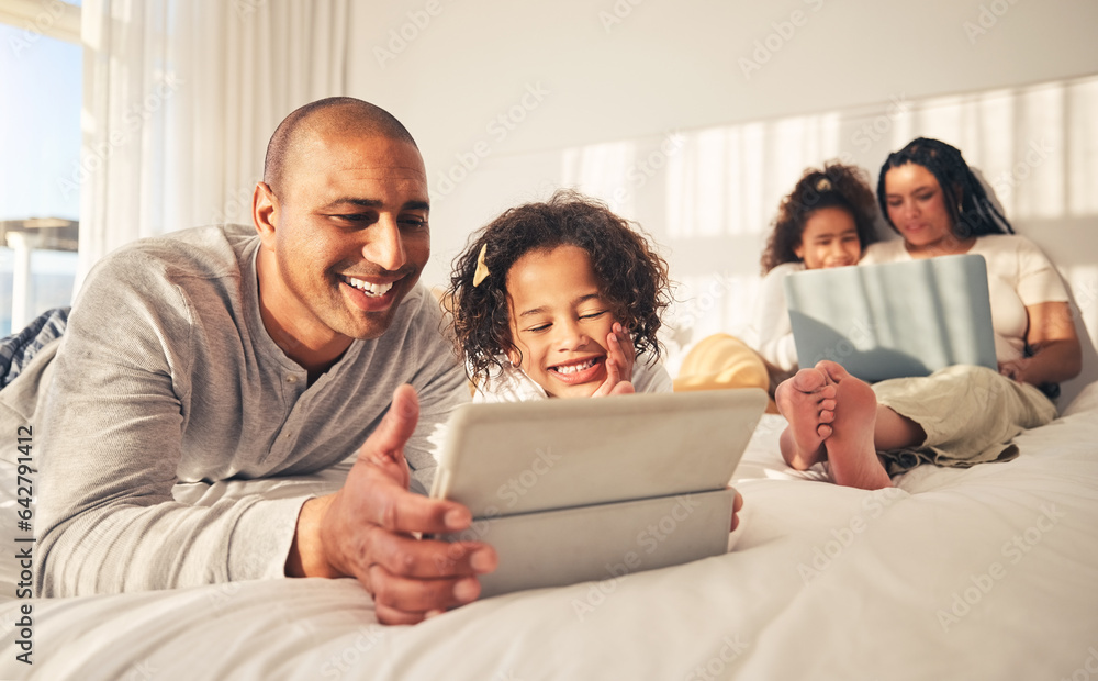 Relax, family and technology in the bedroom for movies, cartoon or education on the internet. Happy, together and parents with girl kids and a laptop and tablet for streaming a show, film or games Relax, family and technology in the bedroom for movies, cartoon or education on the internet. Happy, together and parents with girl kids and a laptop and tablet for streaming a show, film or games
