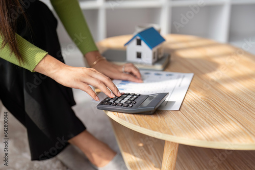 Foto Woman renter using calculator for business financial accounting calculate money
