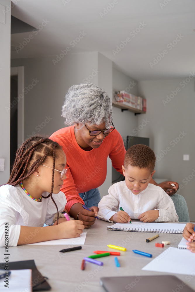 African mother painting with their children during the freetime at home. African mother painting with their children during the freetime at home.
