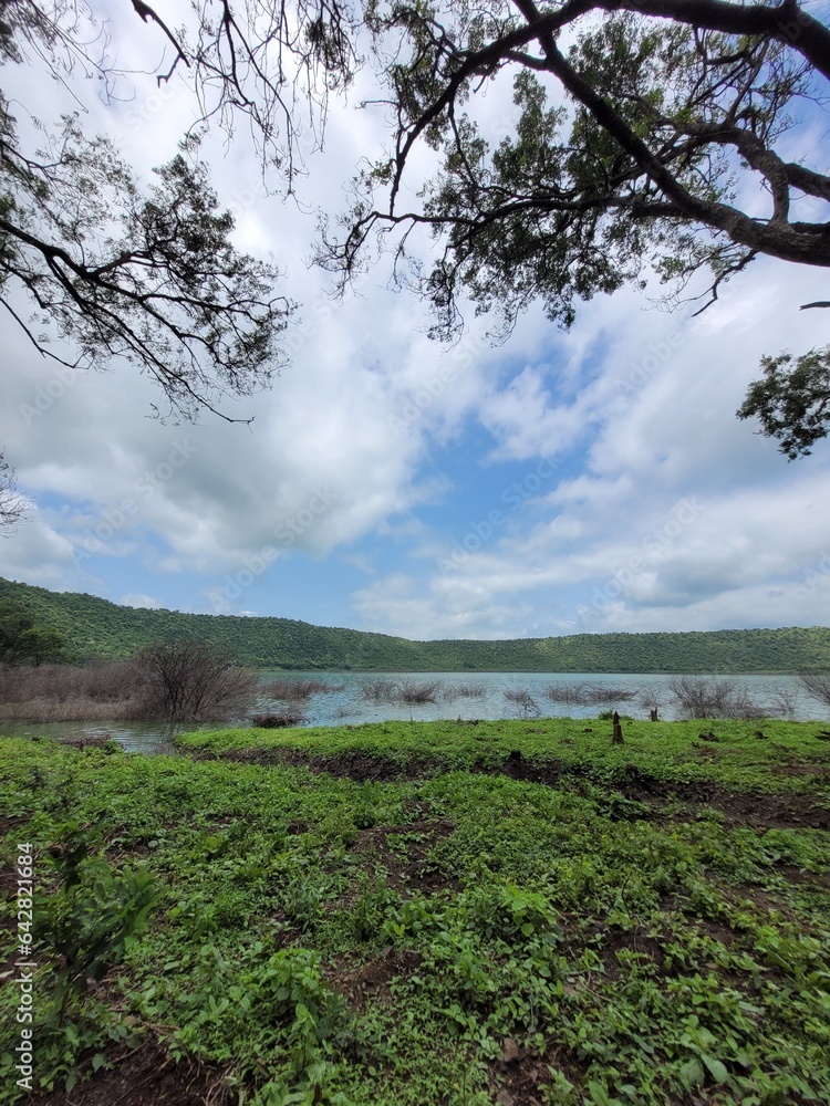 Obraz premium Lonar Lake, also known as Lonar crater, is a notified National Geo-heritage Monument,[2][3][4] saline, soda lake, located at Lonar in Buldhana district, Maharashtra, India. Lonar Lake is an astrobleme