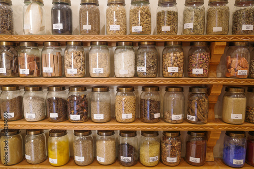 Marrakech, Morocco - Feb 8, 2023: Jars of dried seeds and spices at the Moroccan Museum of Culinary Arts © Mark