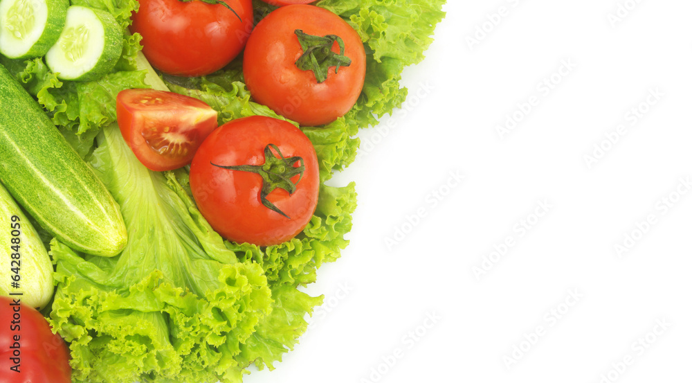Red pepper, cucumbers and tomatoes on salad leaves background isolated on white. 