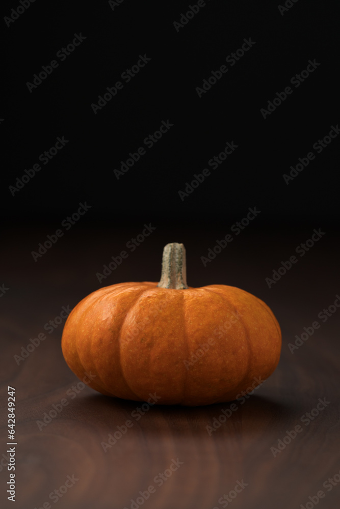 Small pumpkin on wood table with copy space background Small pumpkin on wood table with copy space background
