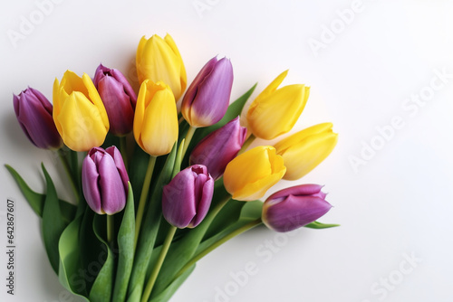 Bouquet of yellow and purple tulips on a white background