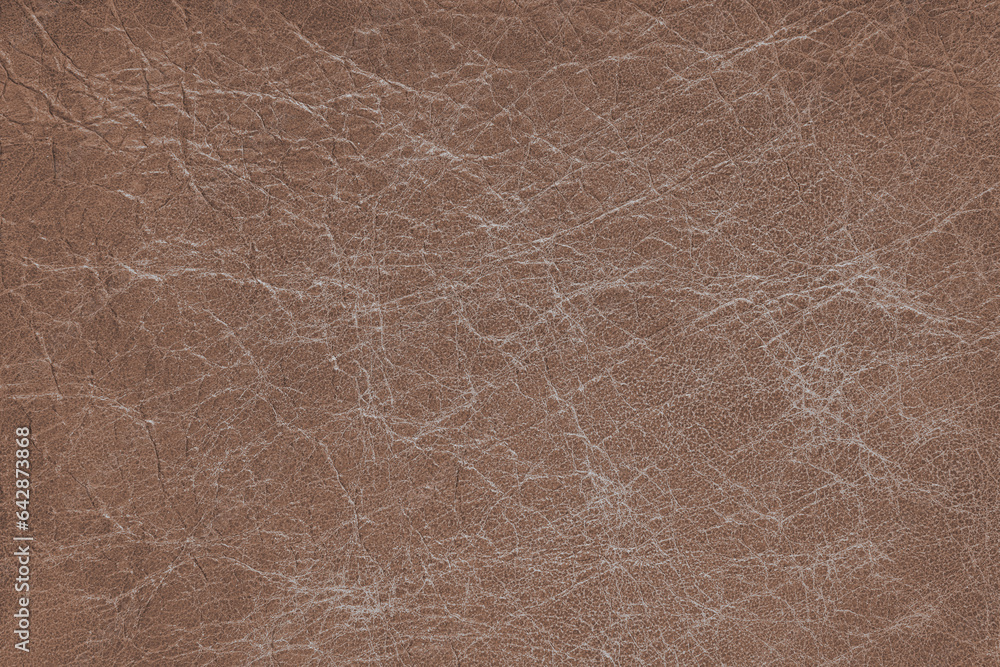 Genuine brown coarse textured leather, eco friendly leatherette background. Material for upholstery and interior design, sport items and clothes. Wallpaper, banner, backdrop.