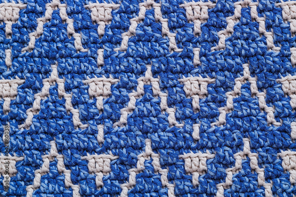 Blue white crochet texture close up with abstract mosaic pattern. Knitted background. Blue white crochet texture close up with abstract mosaic pattern. Knitted background.