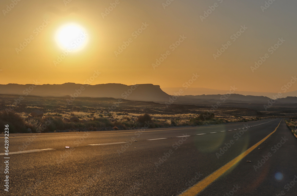 Sunrise drive over desert cliffs