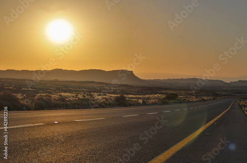 Sunrise drive over desert cliffs