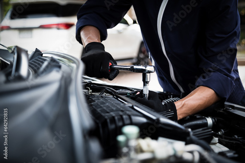 Automobile mechanic repairman hands repairing a car engine automotive workshop with a wrench, car service and maintenance , Repair service