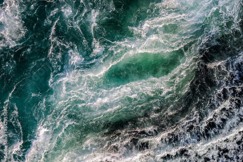 Blue waves of water of the river and the sea meet each other during high tide and low tide.