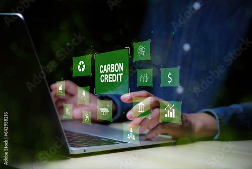 Green energy, Carbon credit market concept. Businessman pointing Carbon credit icon. Net zero in 2050 year. Green energy icon around it. Carbon Neutral in industry Net zero emission eco energy..