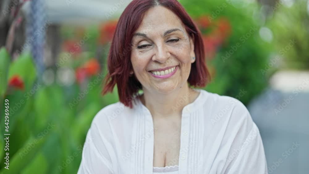 Middle age woman smiling confident standing at park Middle age woman smiling confident standing at park