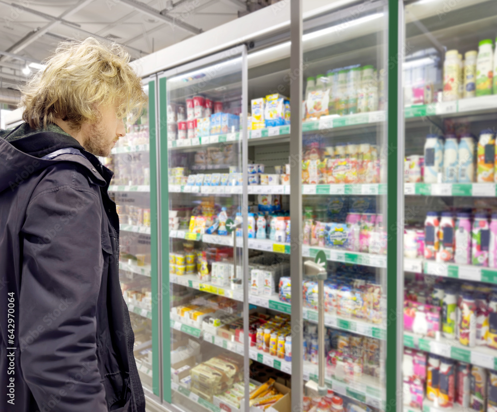 choosing products in the supermarket refrigerator