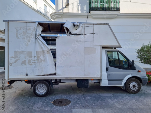 damaged truck parked on the street