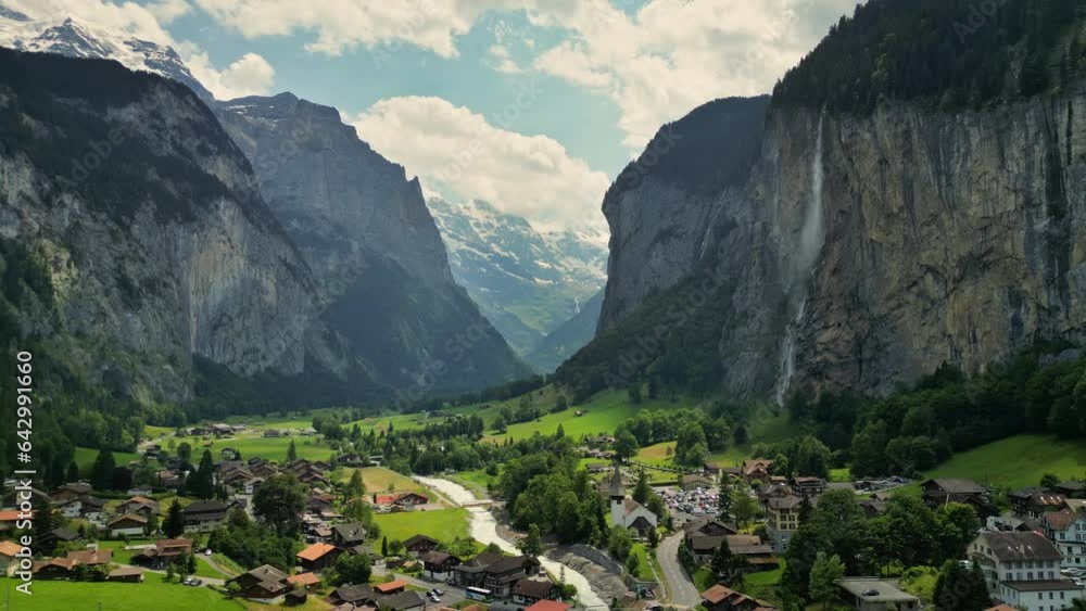 Fly over Swiss alpine village Lauterbrunnen. Aerial view of