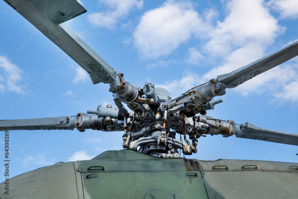 Bushings and automatic-skew helicopter gray against the background of clouds on a clear sunny day Military equipment atom planes missiles helicopters. Bushings and automatic-skew helicopter gray against the background of clouds on a clear sunny day Military equipment atom planes missiles helicopters.