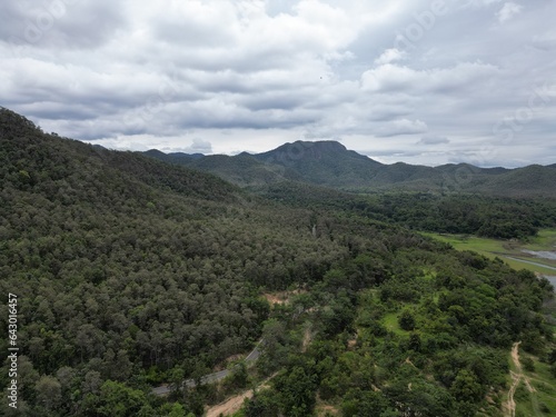 Beautiful natural scenery of a river in Southeast Asia, tropical forest with mountains in the background, aerial view, drone shot.