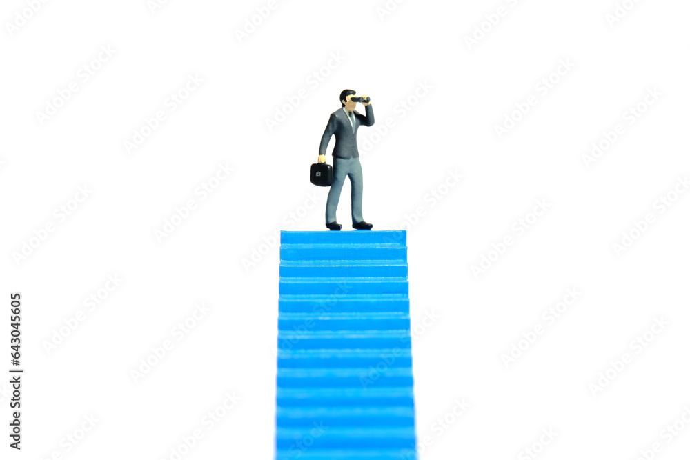 Miniature tiny people toys photography. Businessman using binocular telescope standing above blue stairway. Isolated on a white background