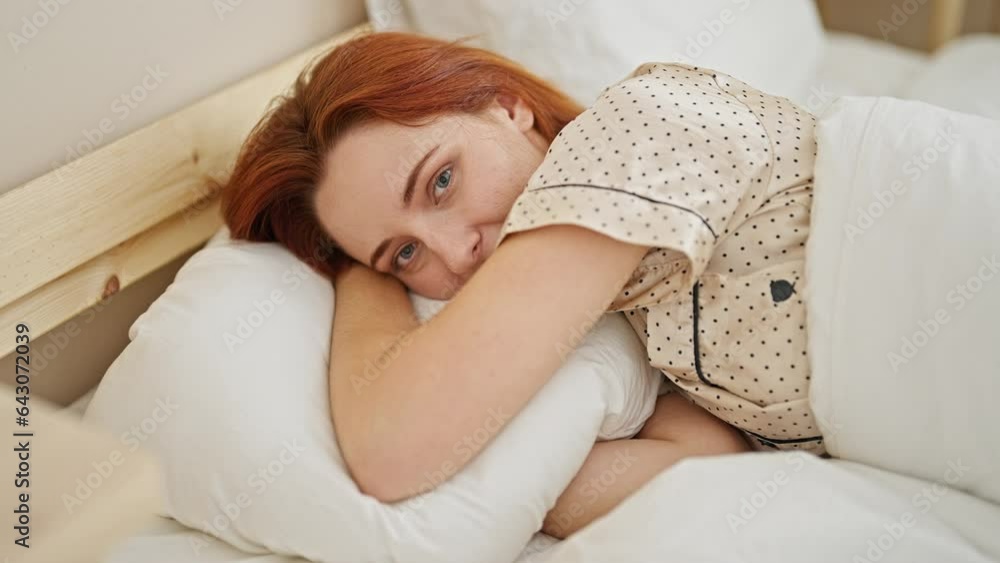 Young redhead woman smiling confident lying on bed at bedroom Young redhead woman smiling confident lying on bed at bedroom