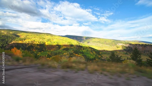 Autumn fall foliage colors from Highway 24 scenic road pov point of view driving car vehicle shot by Minturn, Colorado with nature landscape view photo