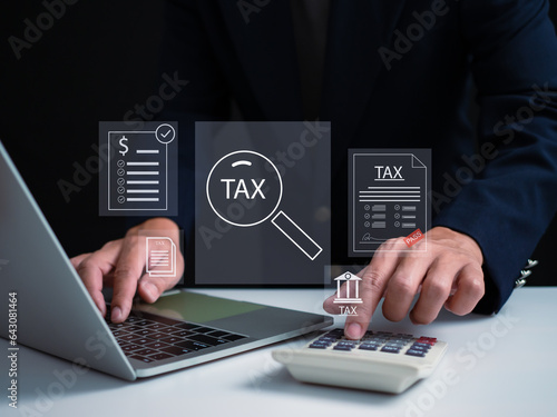 Businessman using a computer to complete Individual income tax return form online for tax payment. financial research, report. Calculation tax return.