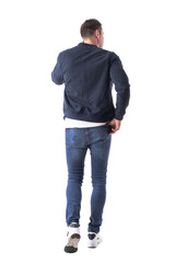 Cool relaxed man with hand in back pocket walking and talking on the phone looking away. Full body isolated on transparent background.
