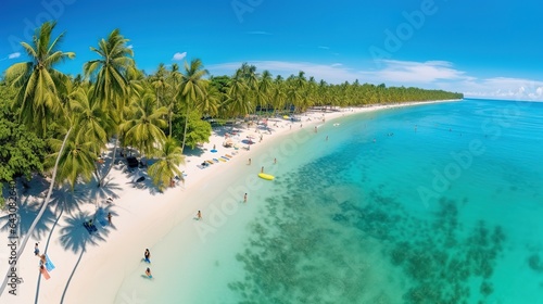 Beautiful summer tropical beach with white sand, palm trees, turquoise ocean water and tourists swimming in clear transparent turquoise water. © arhendrix