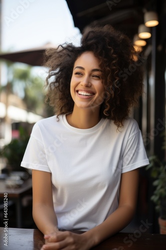 Candid Street Cafe Mockup with Youthful Model in Bella Canvas 3001 Shirt Laughing