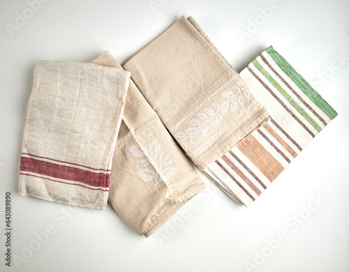 Napkins and towels on white background. Kitchen textiles, top view