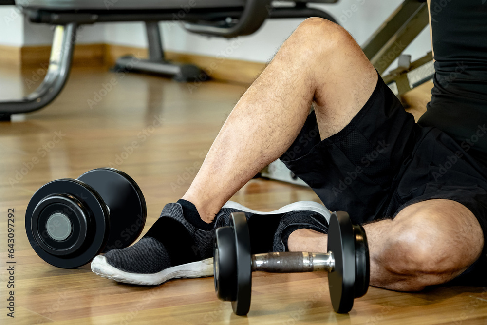 Male athlete massaging his wrist and hand suffering from wrist pain