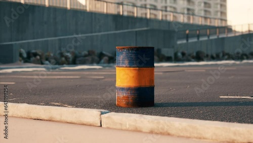 old and rusty metal barrel on parking photo