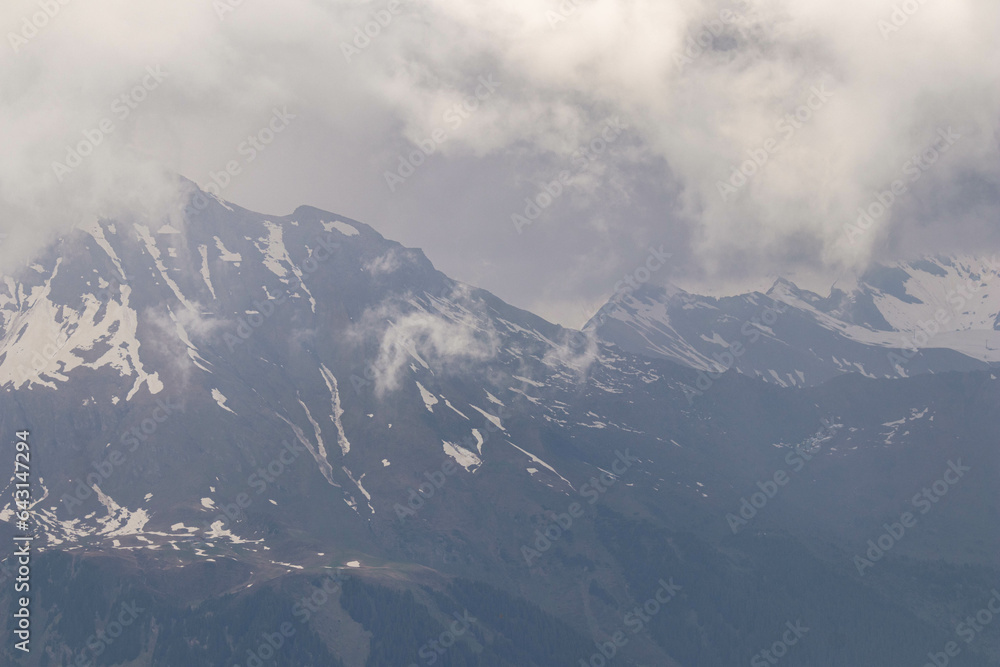 The Swiss Alps with Buildings Sitting Along the Hills and Mountains in the background in Switzerland in Summer