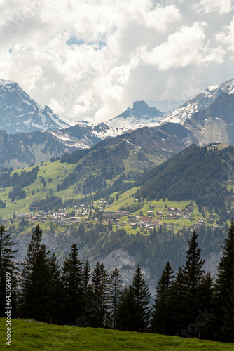 Swiss Alps in Switzerland in the Summer with Mountains Peaking Through Clouds in the Background