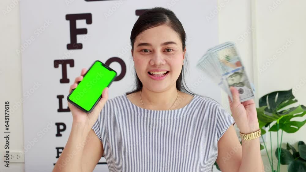 Woman holding mobile phone with money Woman holding mobile phone with money