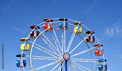 Large Ferris Wheel amusement park ride under blue sky