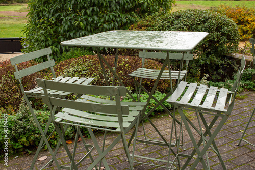 wet coffee table chairs heavy rain autumn