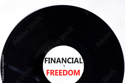 Financial freedom symbol. Concept words Financial freedom on beautiful black vinyl disk. Beautiful white table white background. Business financial freedom concept. Copy space.