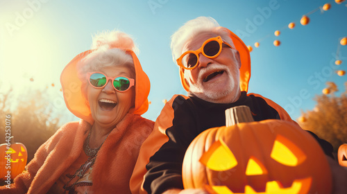 Fotografia A vibrant orange sky envelops two happy people celebrating the autumn season wit