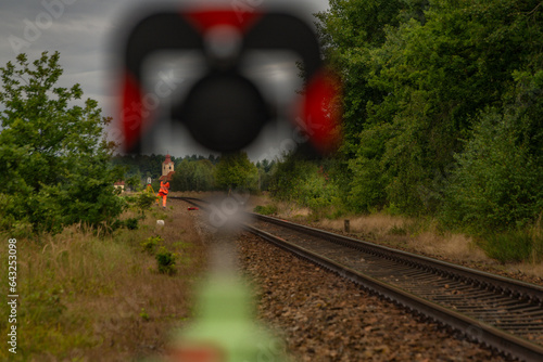 Surveyors with instruments on railway track near green forest in south Bohemia photo