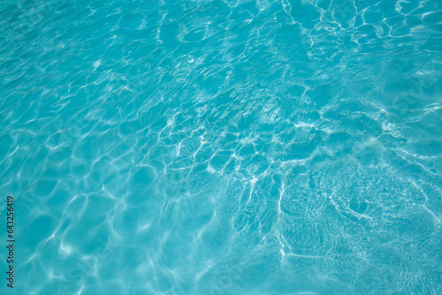 Pool water, cool blue, filling the entire frame. High resolution background or texture asset.