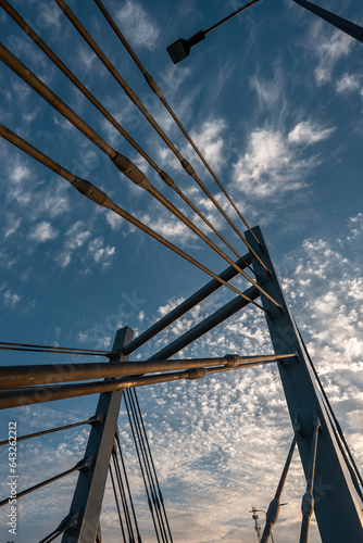 modern metal cable bridge on blue sky background at sunset, Lublin photo