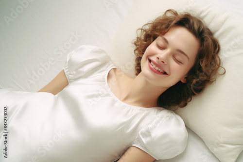 Woman peacefully lying in bed with her eyes closed. Suitable for sleep  relaxation  and bedroom-related concepts.