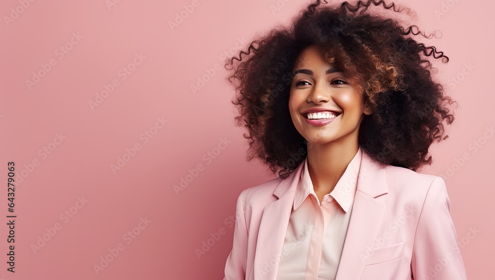 Happy black woman in front of a pink background wall.