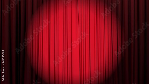 Spotlight directed at red silk curtains