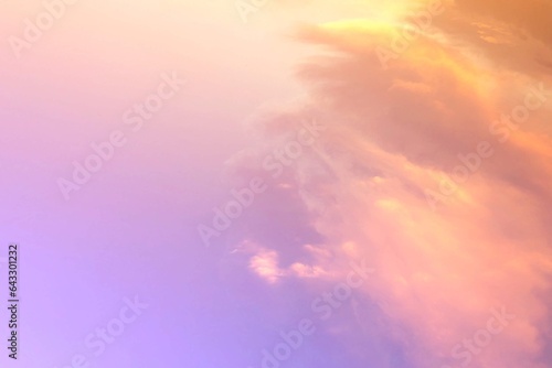 The background of the gentle twilight natural sky is brightened by pastel gradations blending orange, blue, purple at sunset in subtle tones, and the white mist of clouds blur adds softness. © Esso